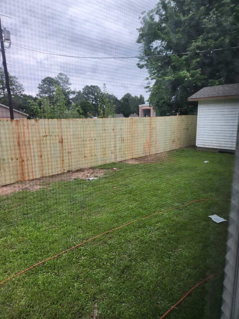 Long wood privacy fence along a backyard
